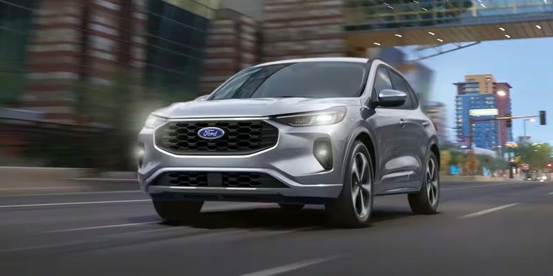 Silver Ford Escape SUV driving on a city road